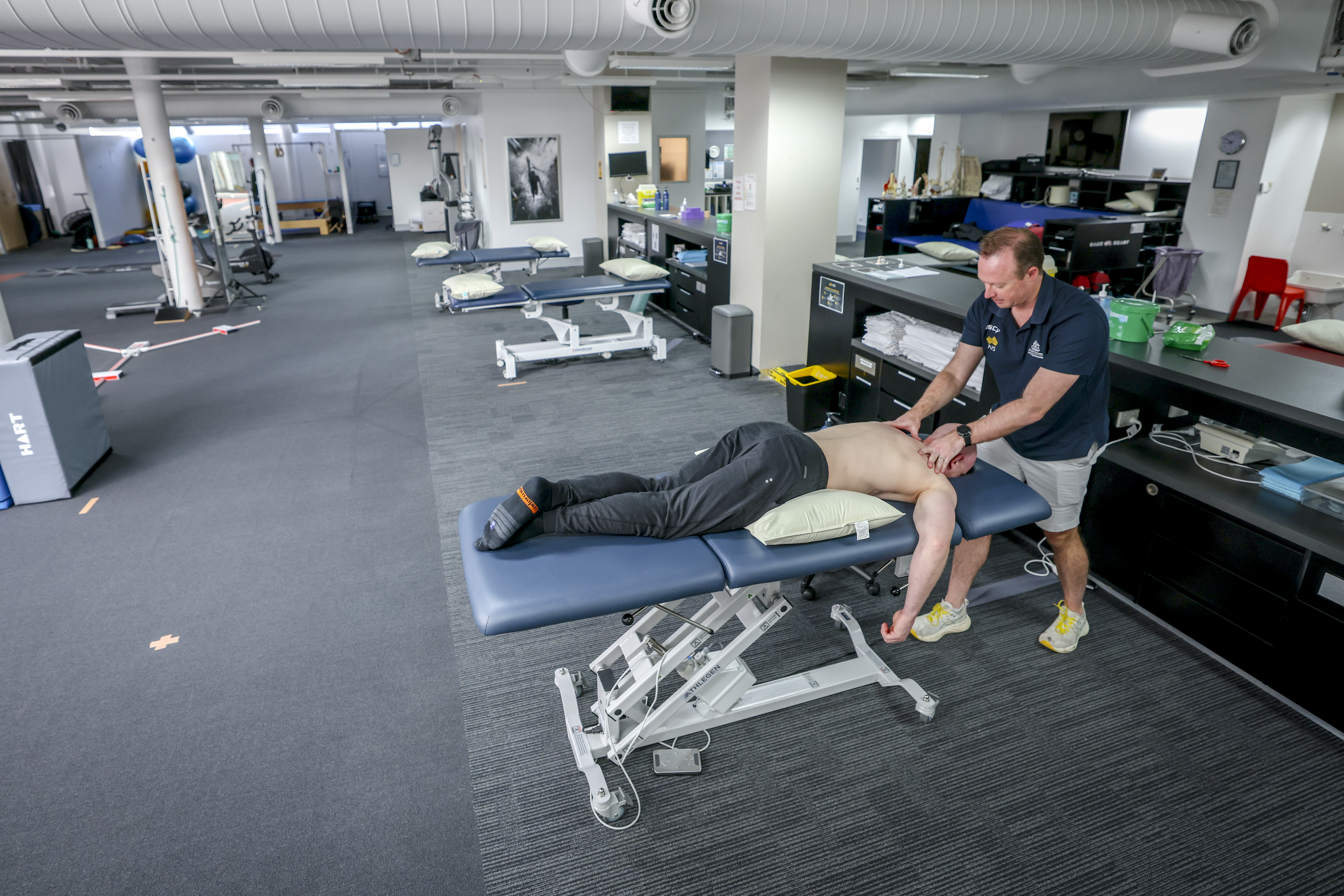 View of the physiotherapy clinic. An athlete is being treated on a table by a physiotherapist