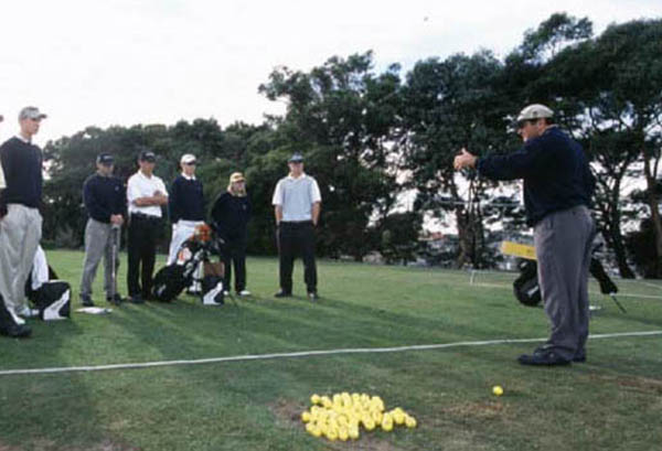 AIS coach speaking to a group of AIS golfers