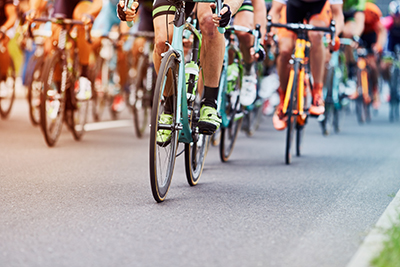 Cyclists competing in a race, riding closely together on a road