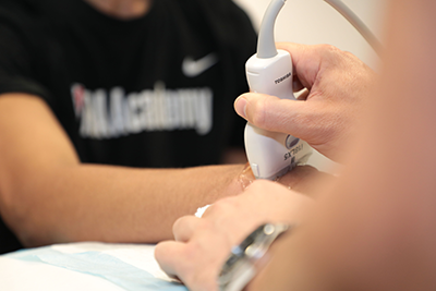 Ultrasound machine on an athlete's wrist.
