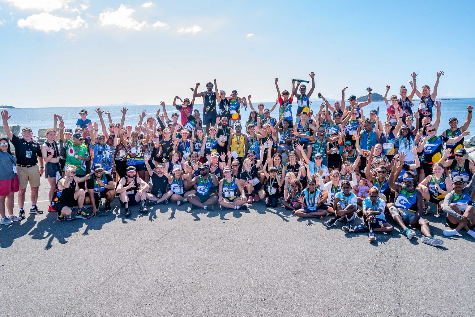 A aerial photo of a crowd gathered beside the beach.