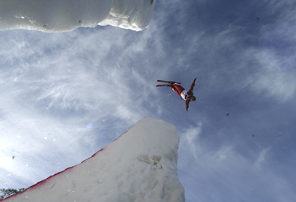 Athlete in the air above the ski jump