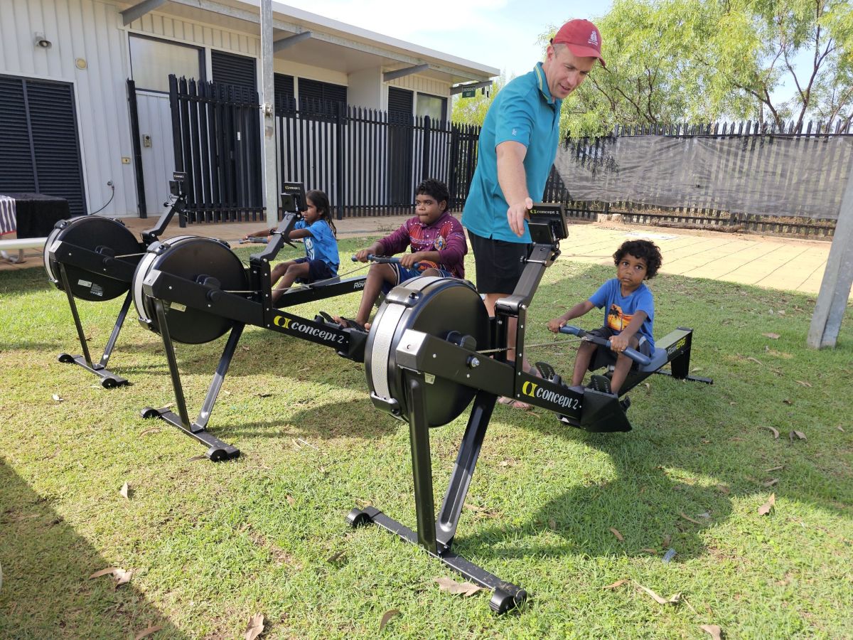 students playing on a rowing erg machine