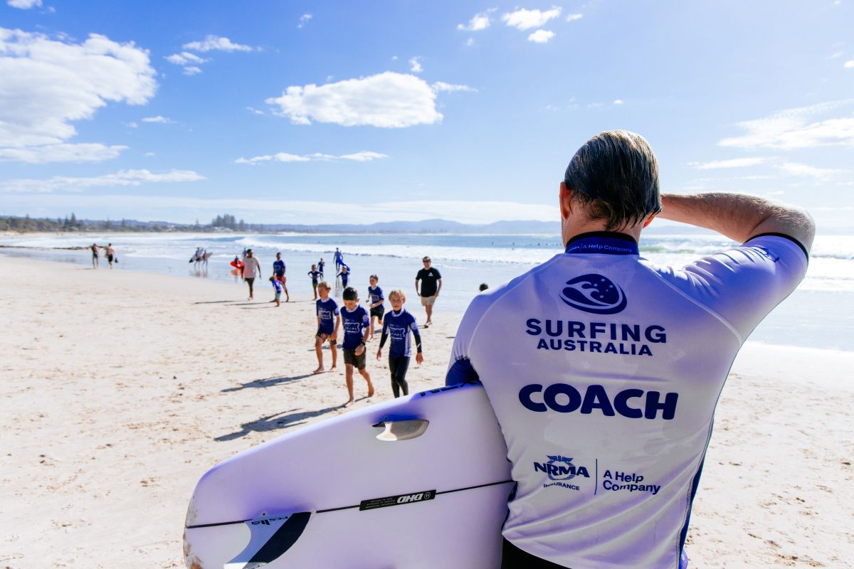 Surf coach at the beach looking out to make sure the kids are having fun and staying safe whilst learning to surf