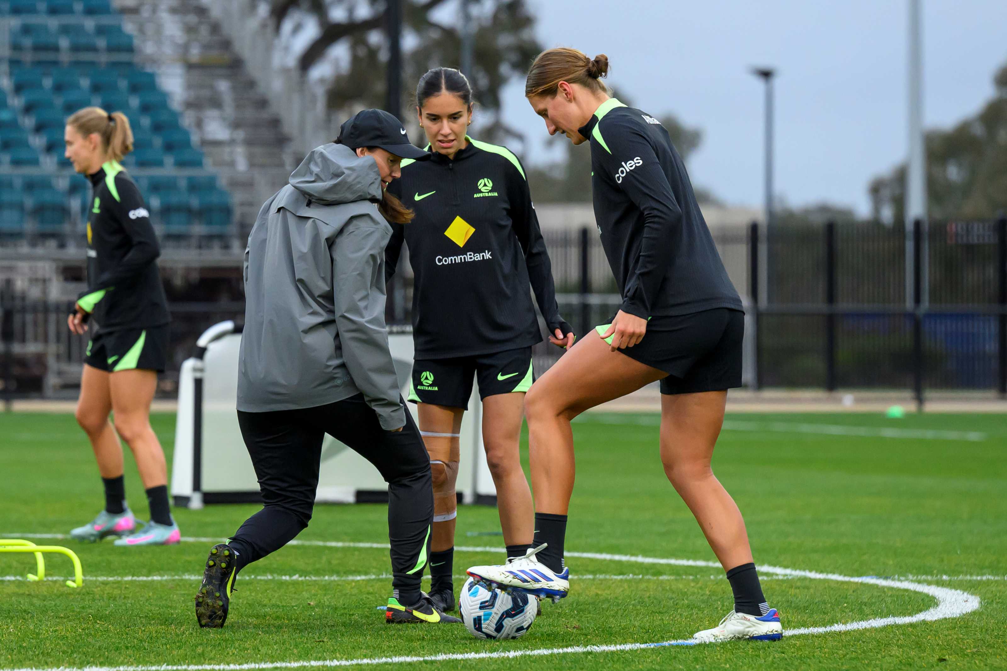 female football coach and players training on field