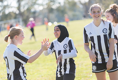 C4S-image- Girls high five on a football field