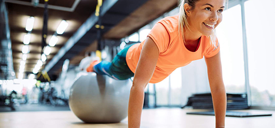 Women doing push ups off a swiss ball
