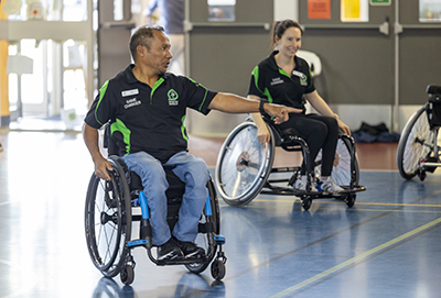 C4S-image-Adult in a wheelchair pointing on an indoor court
