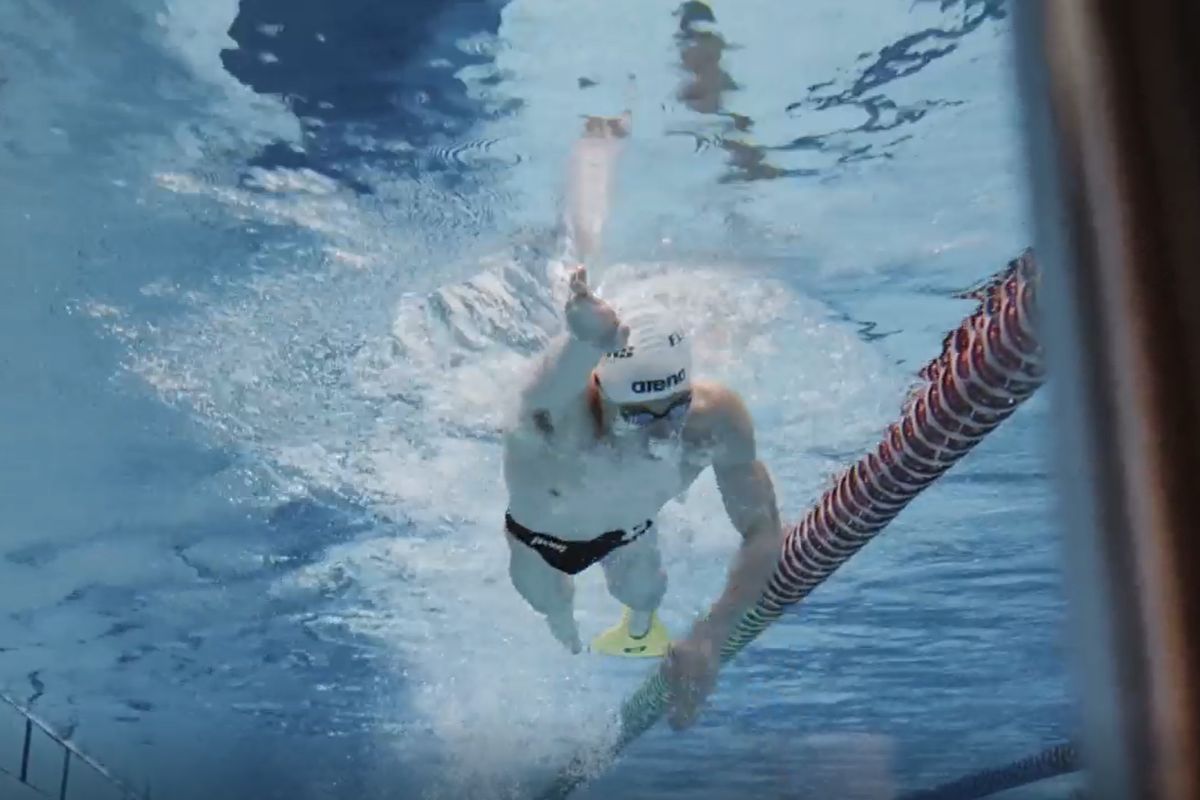 Para-Swimmer Daniel Rigby mid-stroke in the water with one fin.