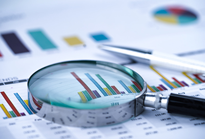 Document showing bar graphs with magnifying glass