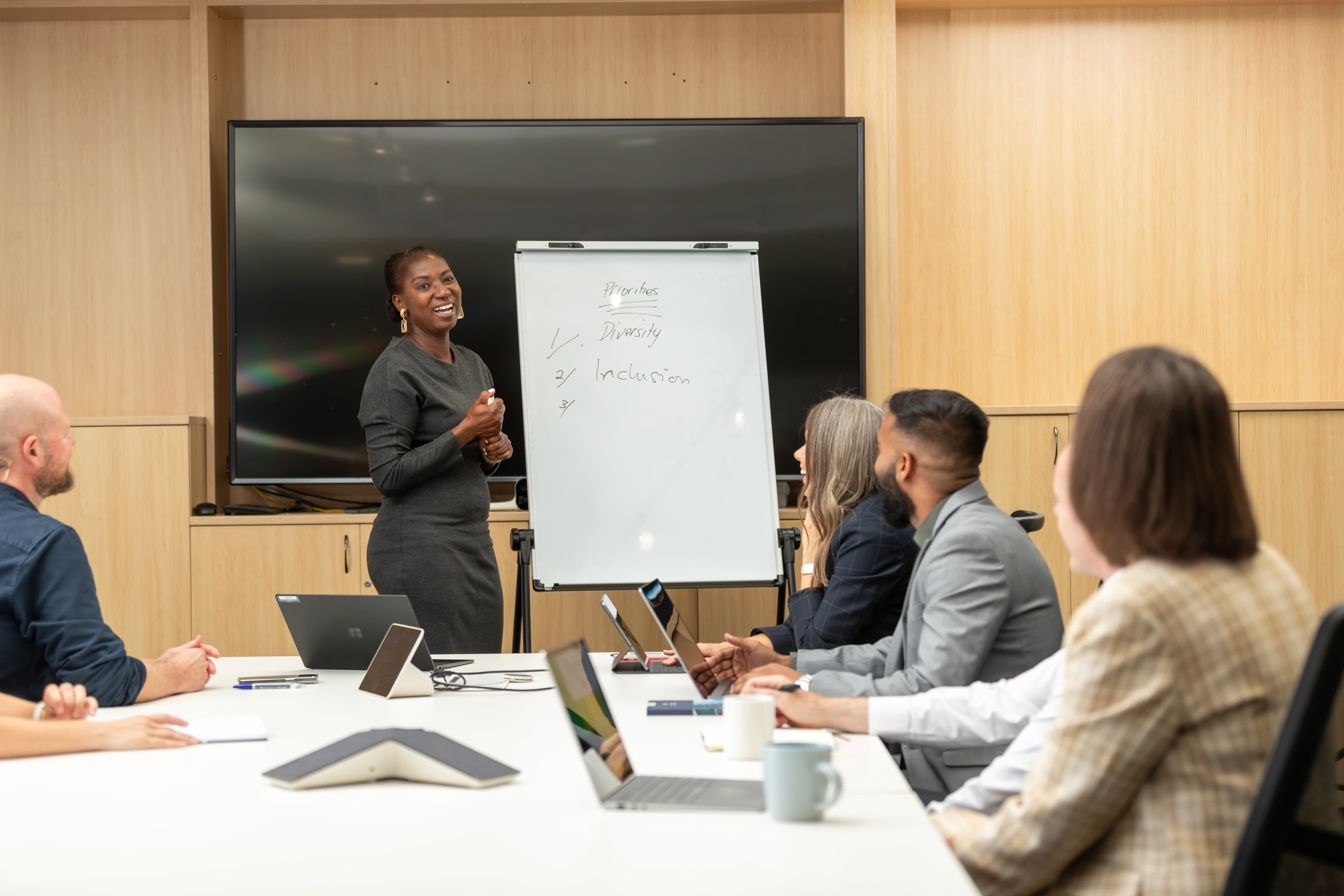 National gender equity tile woman presenting to board