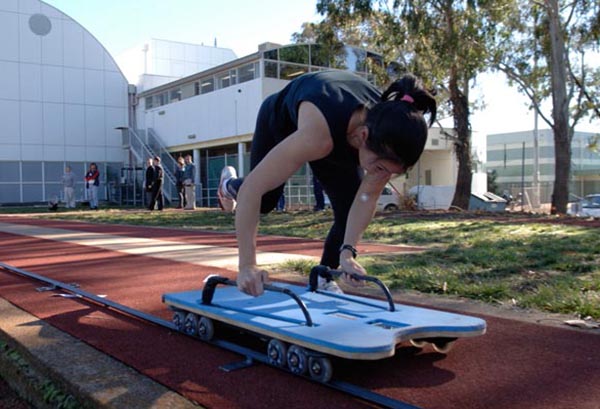 Athlete running on the testing track outside the AIS Biomechanics Dome