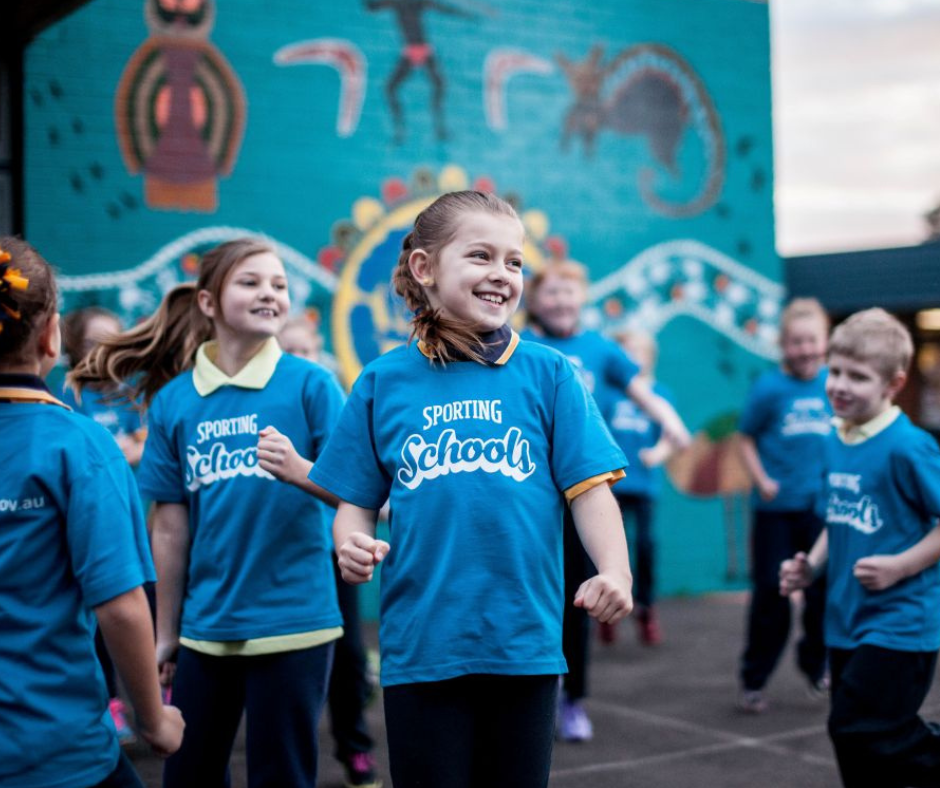 Students playing and smiling during a PE lesson at school
