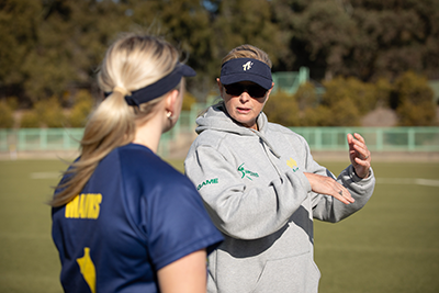 Brooke Penfold, Softball Australia coach, speaking to an athlete during training