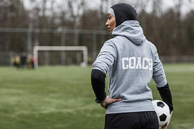 C4S-image-Female coach holding a soccer ball.