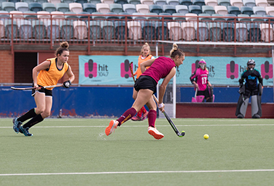 C4S-Image-Female hockey player controlling the ball with defenders nearby
