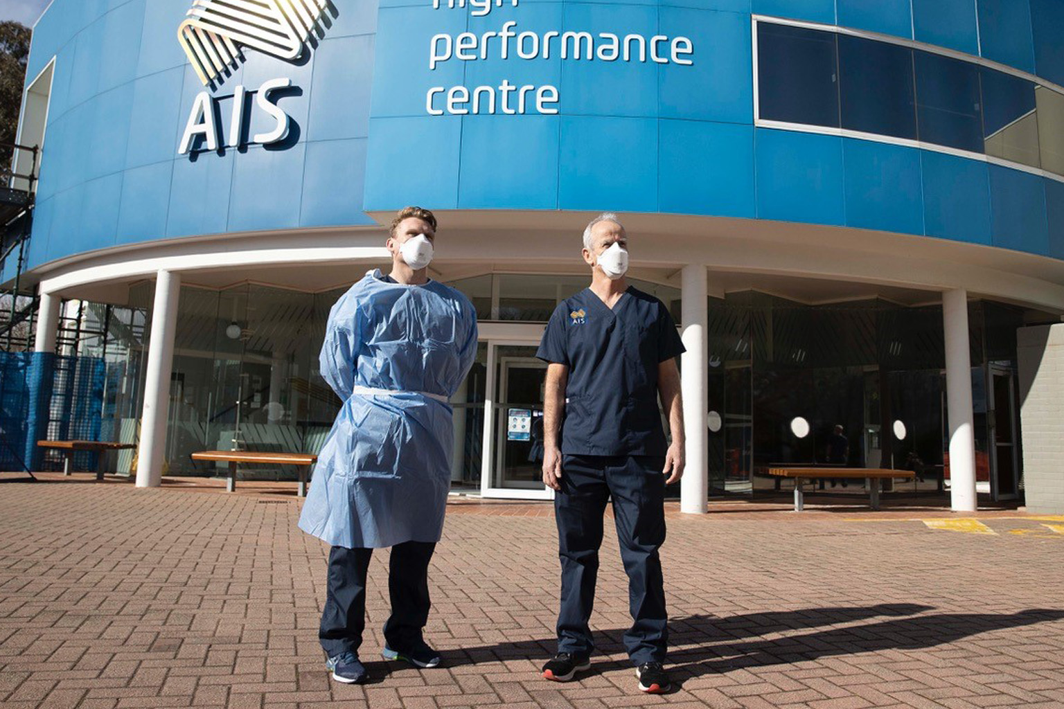 AIS Chief Medical Officer Dr Hughes and AIS PhD Scholar Dr Mat Mooney stand outside the AIS.