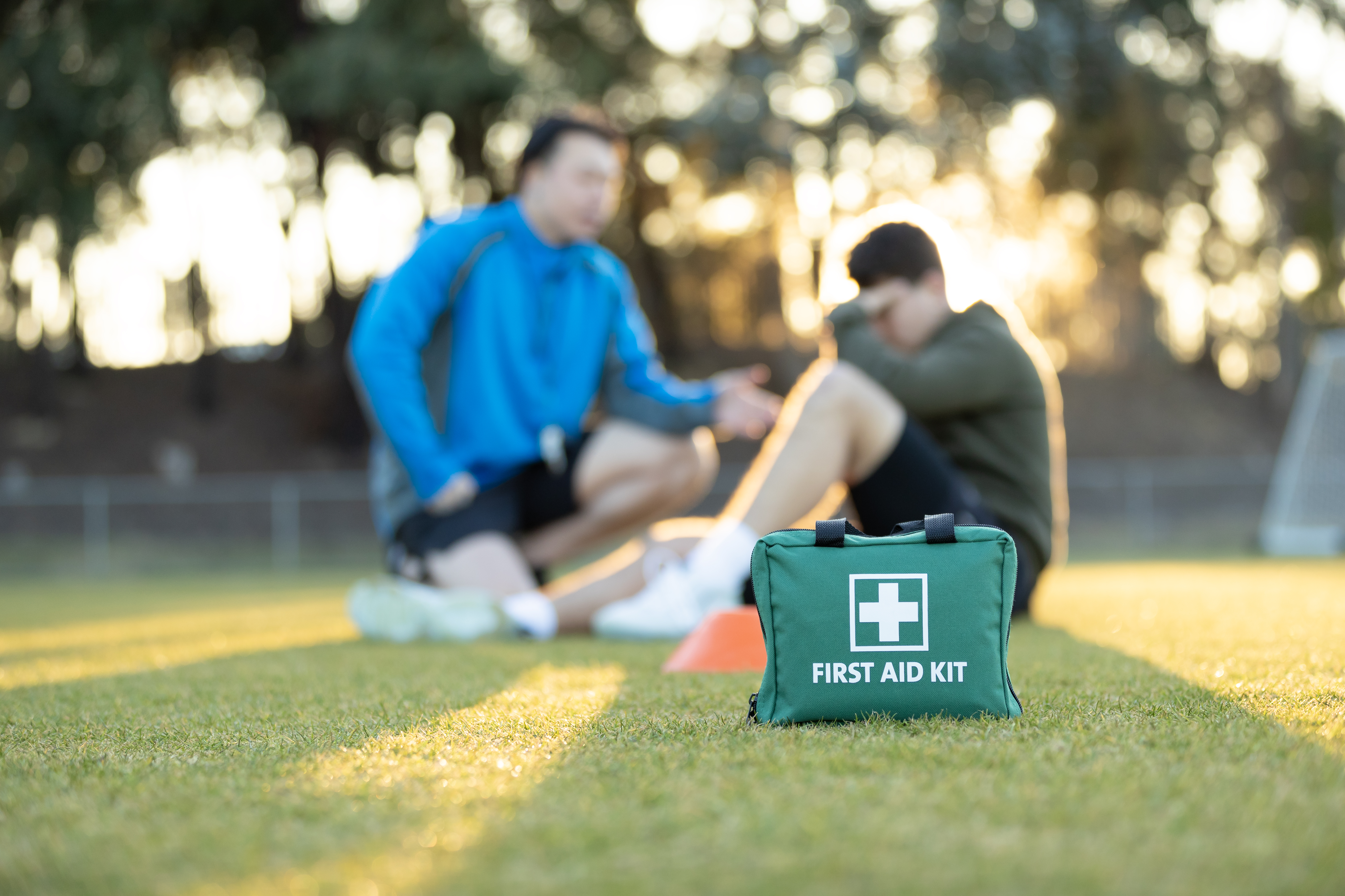 Image of young athlete receiving medical attention on field.
