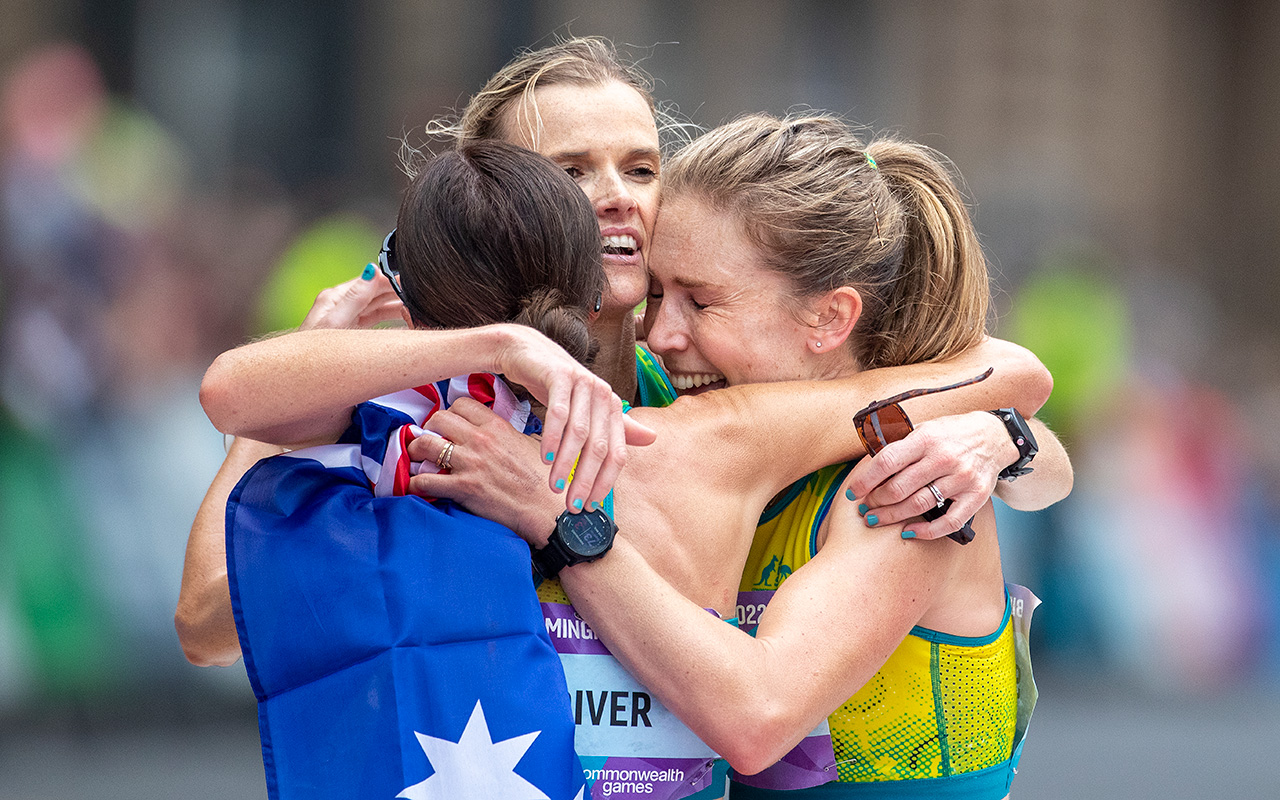 Australian Gold medal winner Jessica Stenson embraces teammates Eloise Wellings and Sinead Diver after the Women's Marathon at the Birmingham 2022 Commonwealth Games. Photo: Getty Images
