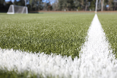 A close up of a corner and lines of the synthetic pitch