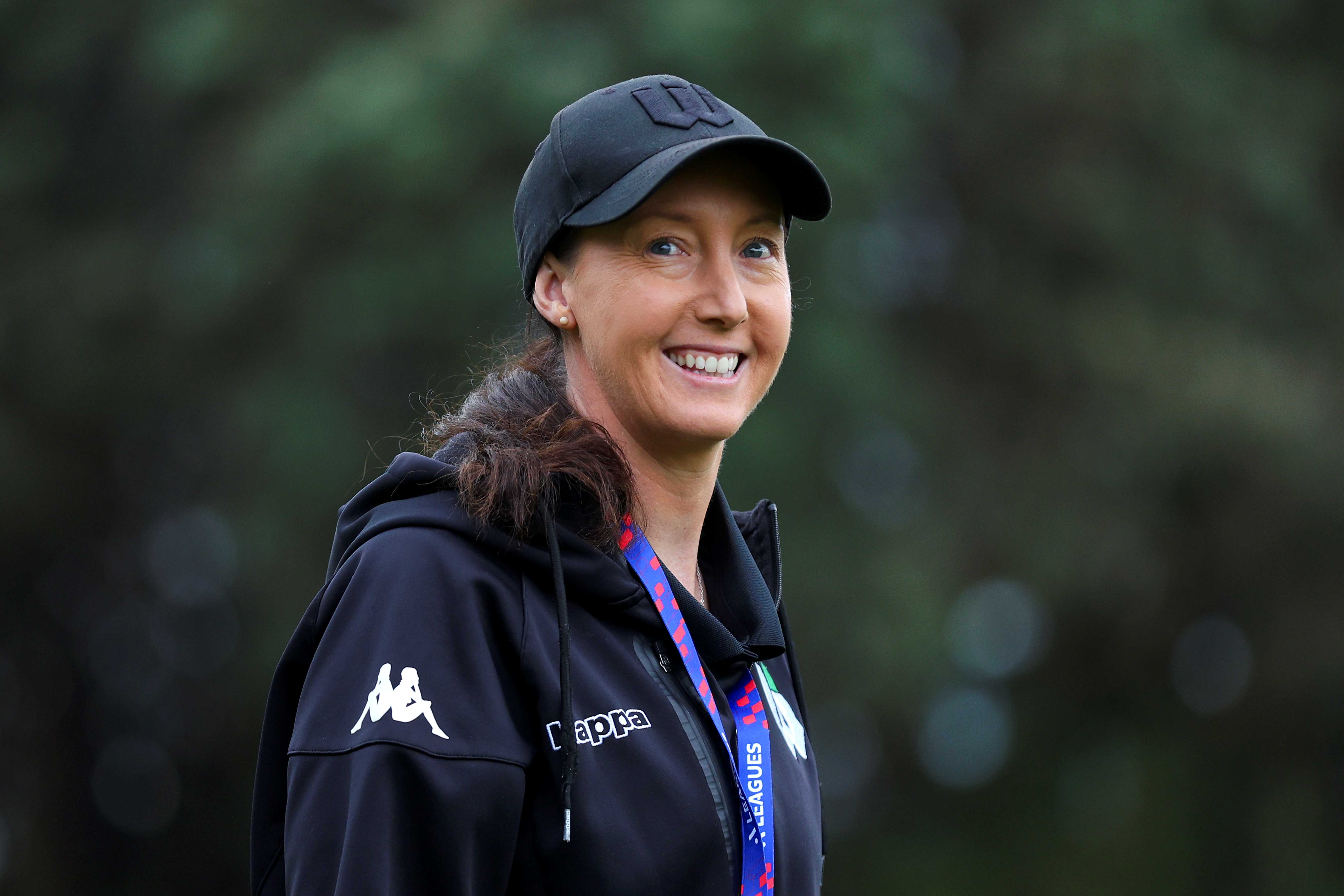 female coach looking at camera and smiling