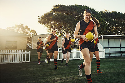 C4S-image-Women run onto a field ready to play Australian football