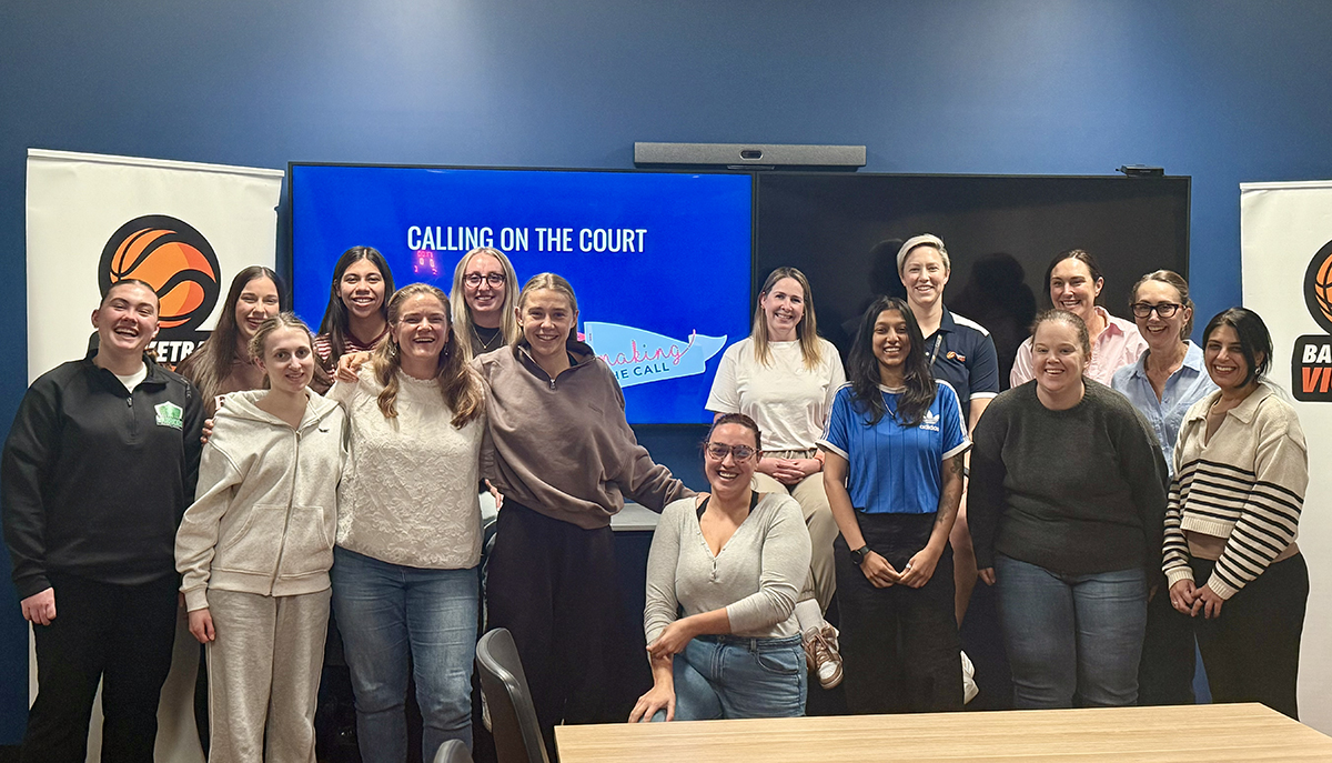 Women standing and sitting around a table after completing a workshop