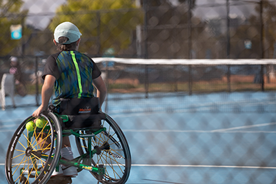 Wheelchair Tennis player holding a racket