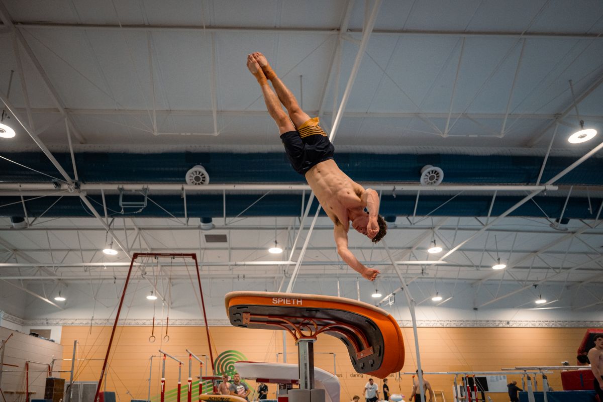Gymnast doing a flip off a vault in the AIS Gymnastics Centre