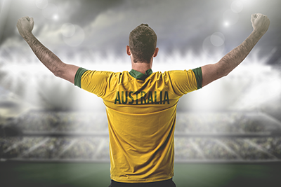 A man in an Australian tshirt cheering
