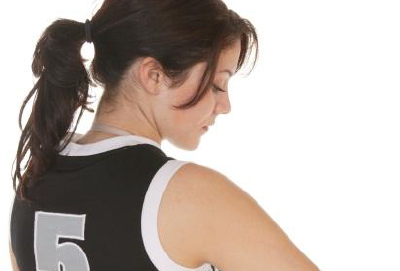 A women in a sport uniform looking down