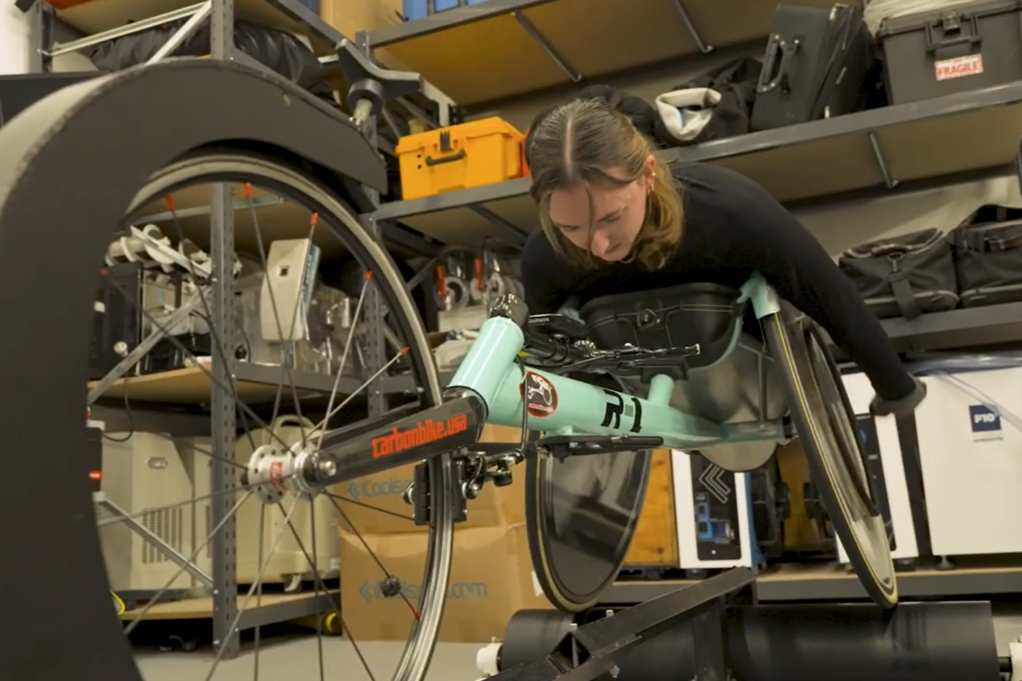 Para-athlete Aimee Fisher practicing on wheelchair racing rollers
