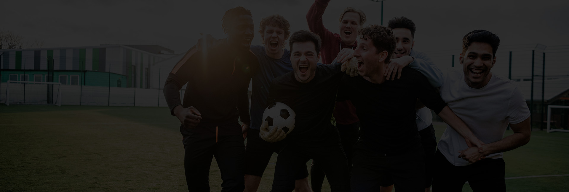 Group of young man hugging and celebrating soccer match success