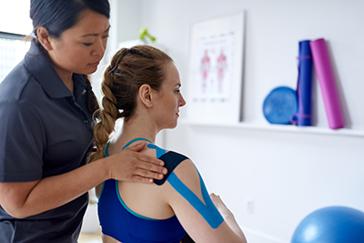 Physio treating a women's shoulder