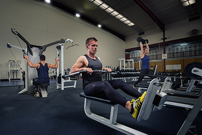 Athletes doing various strength exercises in the gym