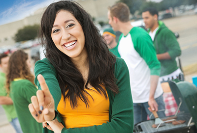 A women smiling with her index finger pointing up
