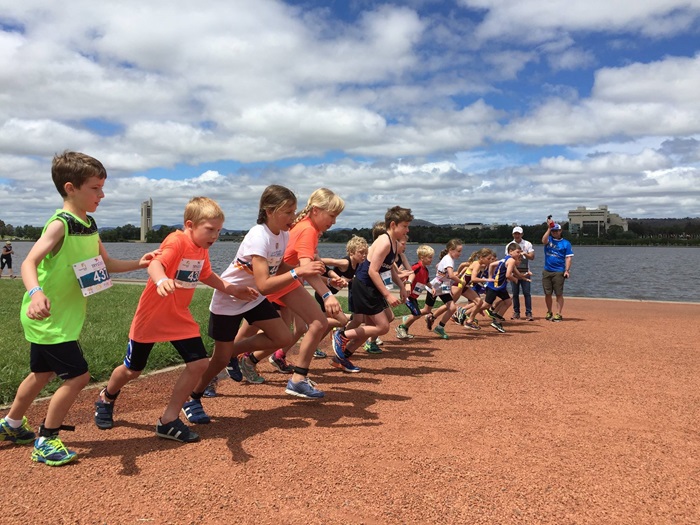 Sporting Schools - Kids running in lake beach