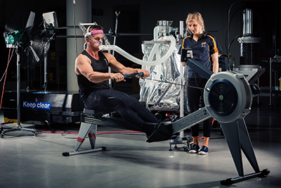 An athlete on a Rowing Ergometer in a Physiology Lab.