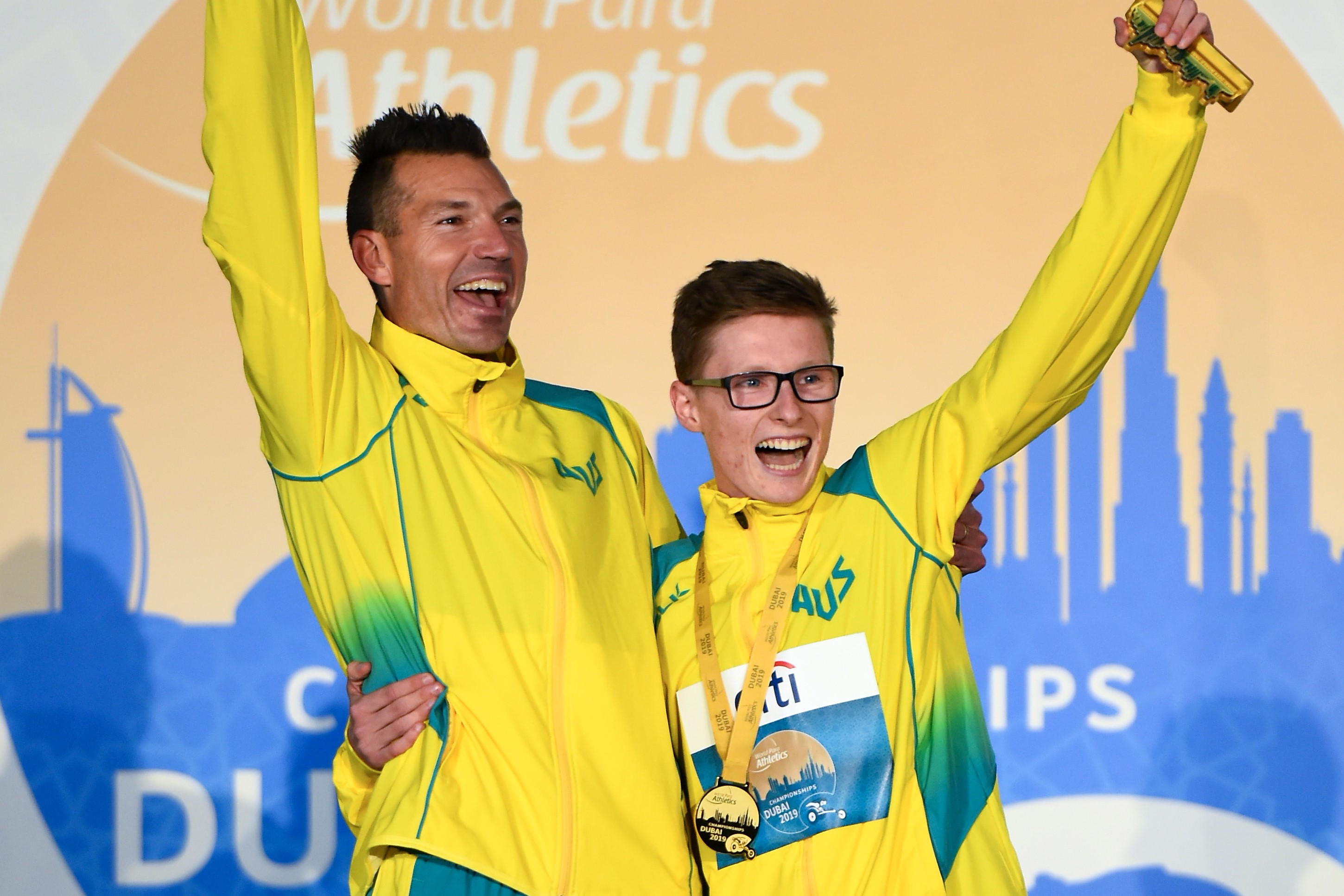 Philo Saunders celebrates with Jaryd Clifford as he is presented with his gold medal after winning the Men's 5000m T13 Final race at the IPC World Para Athletics Championships 2019.