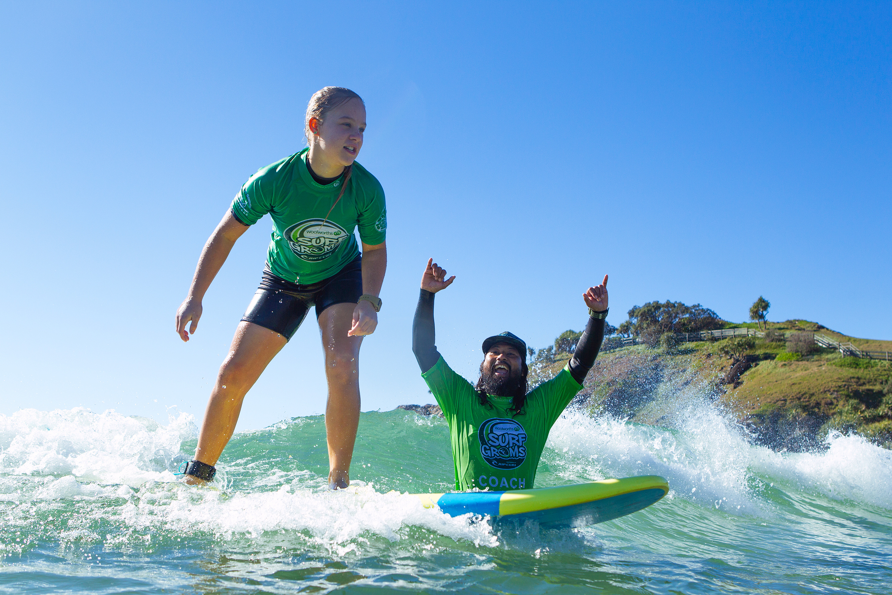 Sporting Schools - Surfing Australia - Girl surfing with instructor