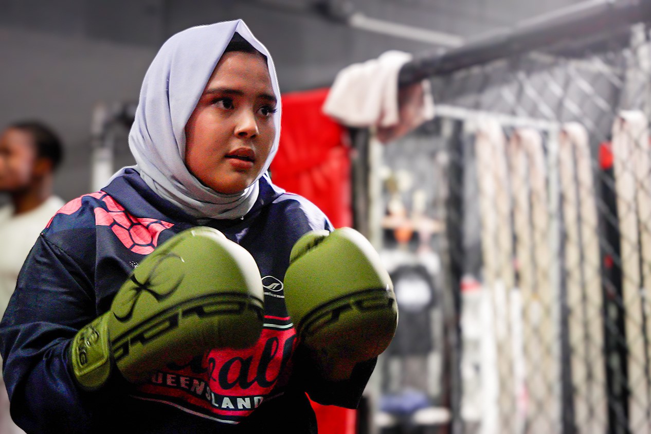 17-year-old Zahra Ahmadi pictured wearing boxing gloves at an indoor training facility.