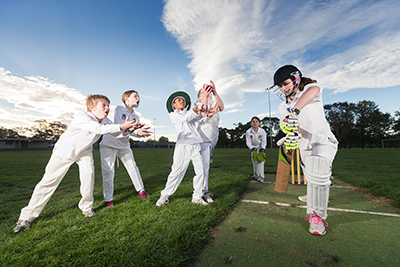 Six children playing cricket