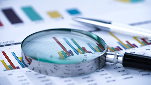 A magnifying glass on a spreadsheet