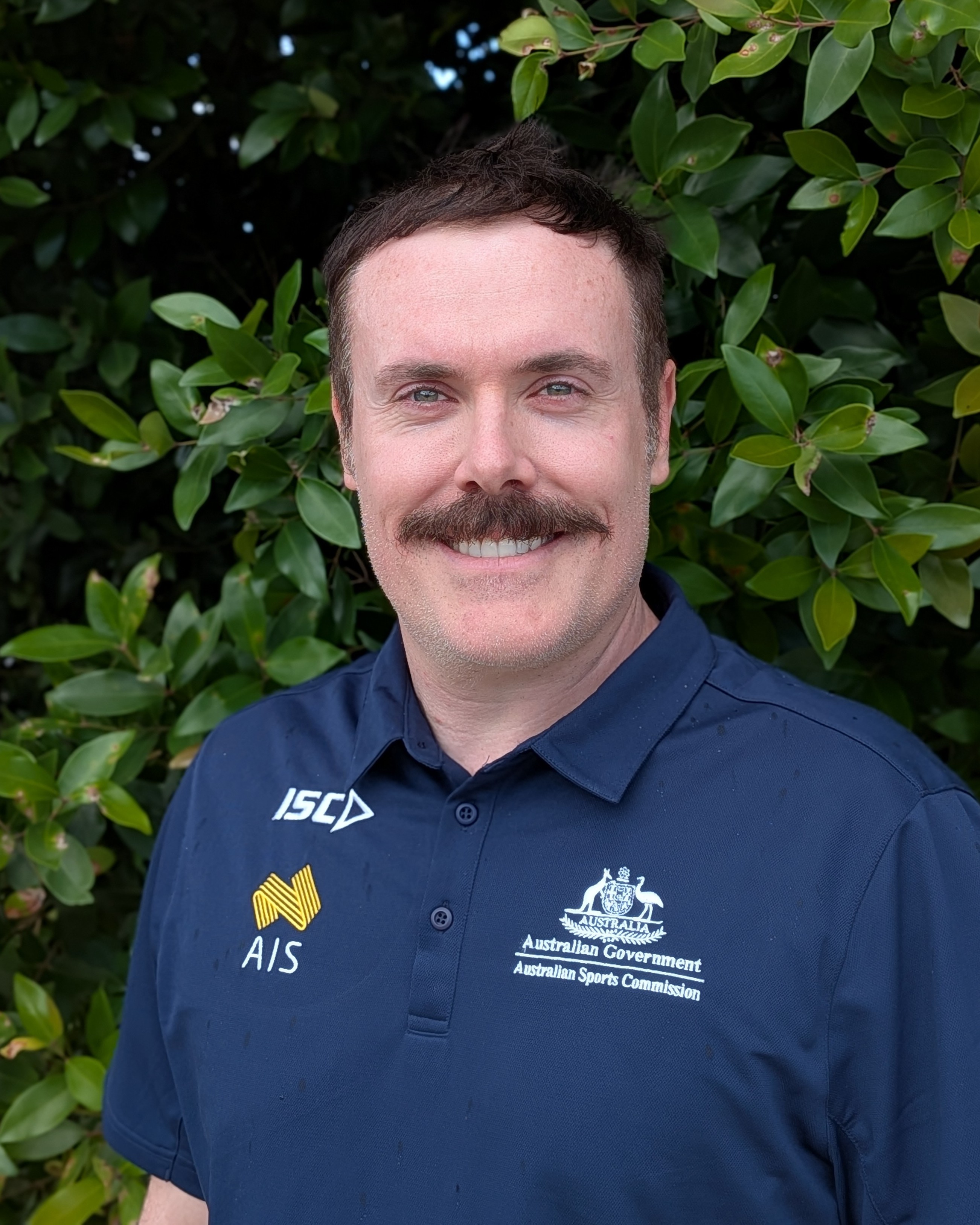 Headshot of Mathew Harris wearing AIS polo