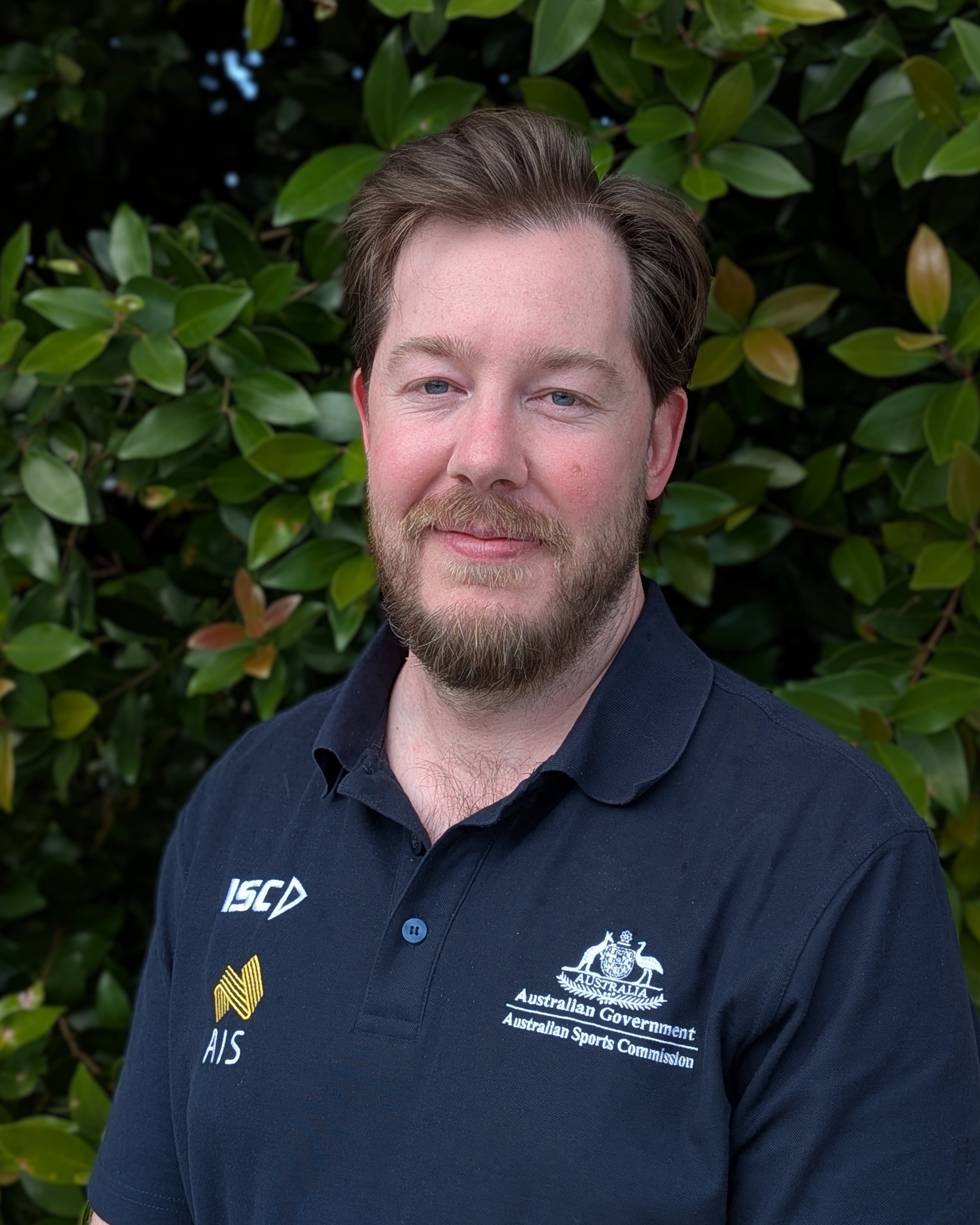 Headshot of Michael Maloney wearing AIS polo