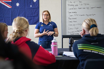 Athletes listening in a classroom