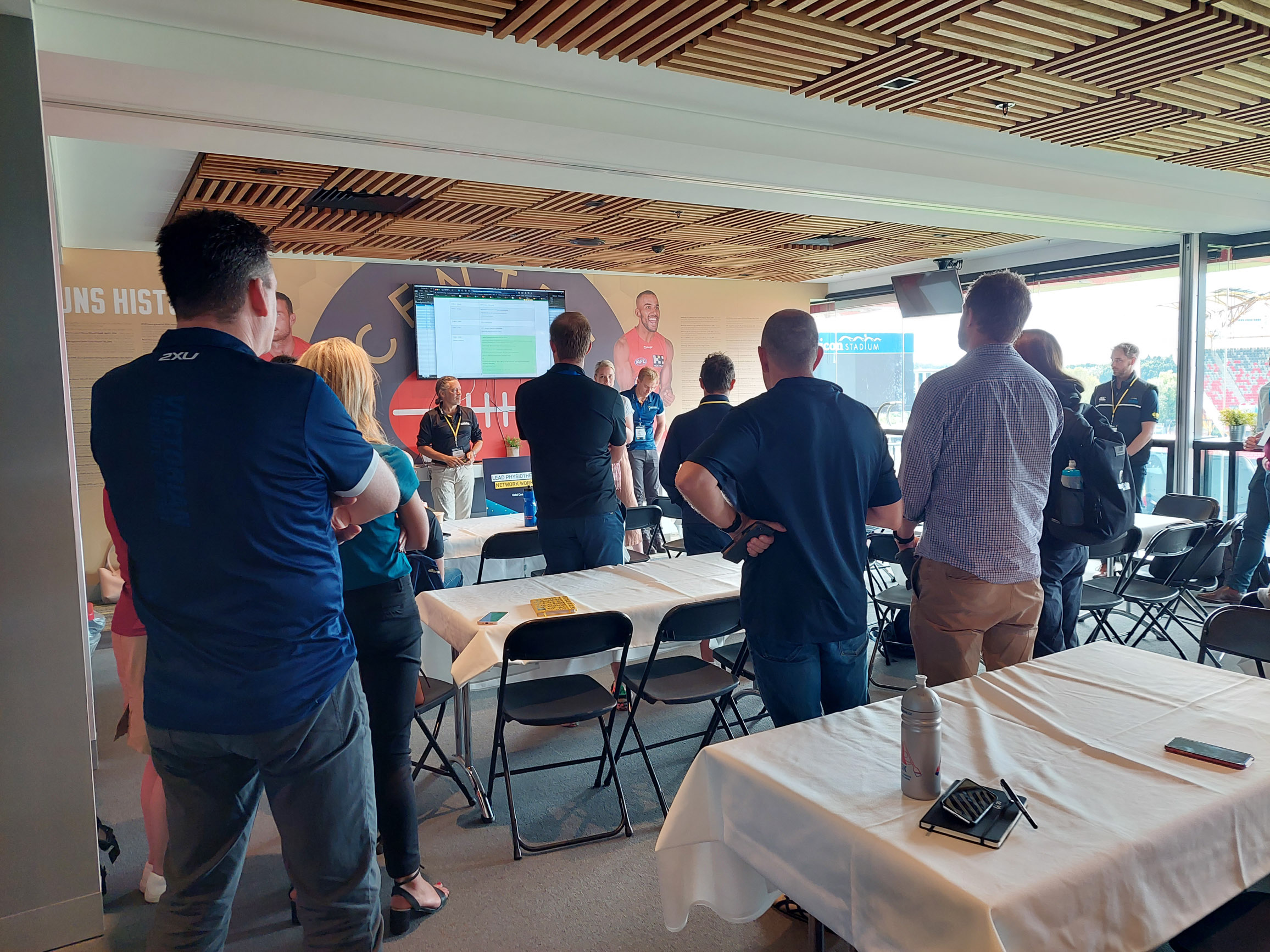 People standing up and networking at conference