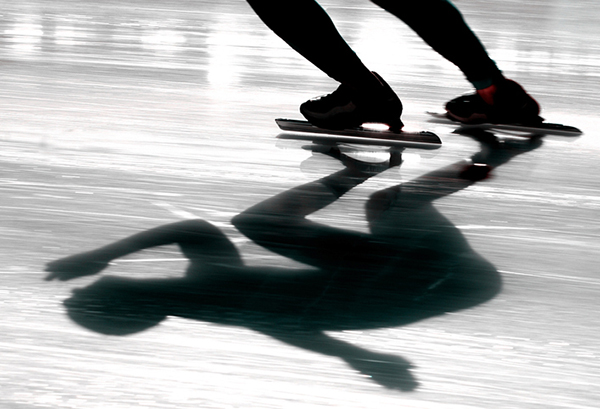 Shadow of a speed skater on the ice