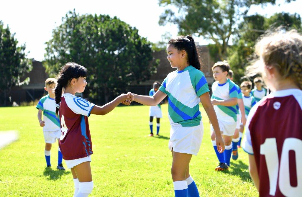 Image of two girls shaking hands football