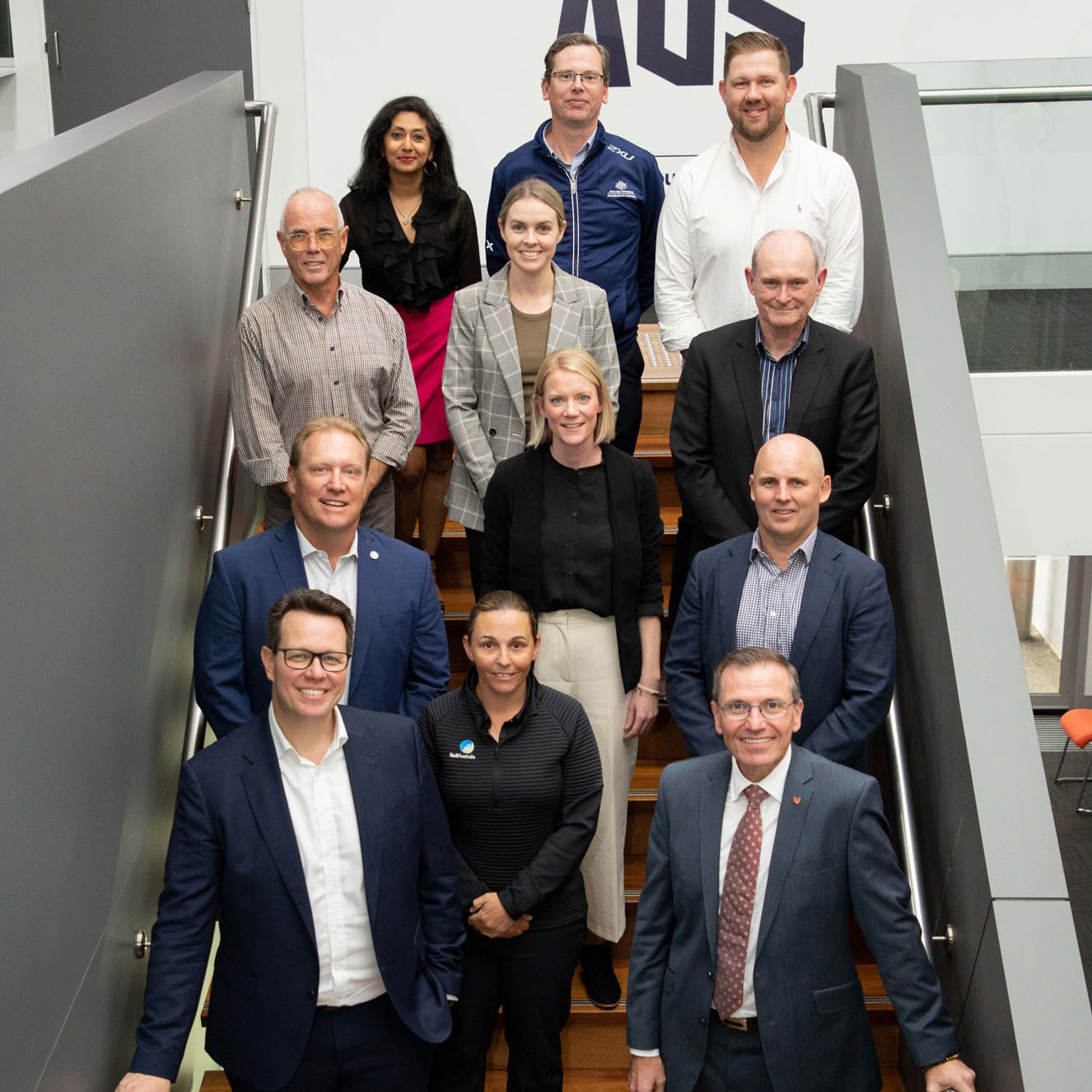 Members of the Sport Volunteer Coalition gather for a group photo in a stairwell.